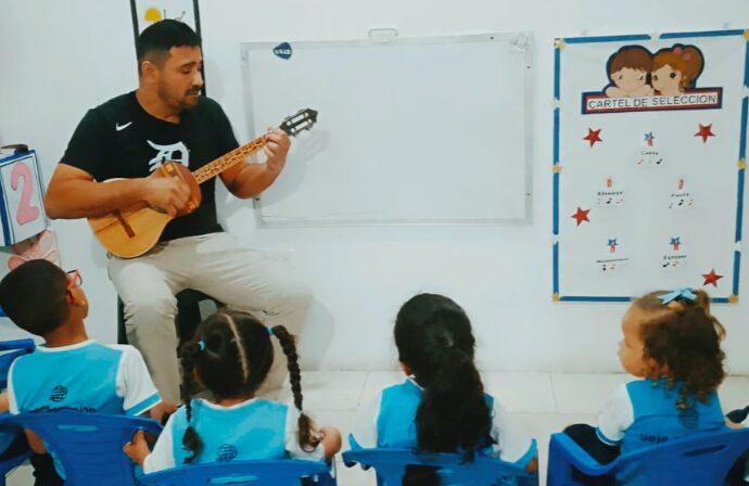 Profesor de inglés utilizando el cuatro venezolano para la enseñanza del idioma bajo el modelo educativo de la U.E. Johnny Escobar en Nueva Esparta.